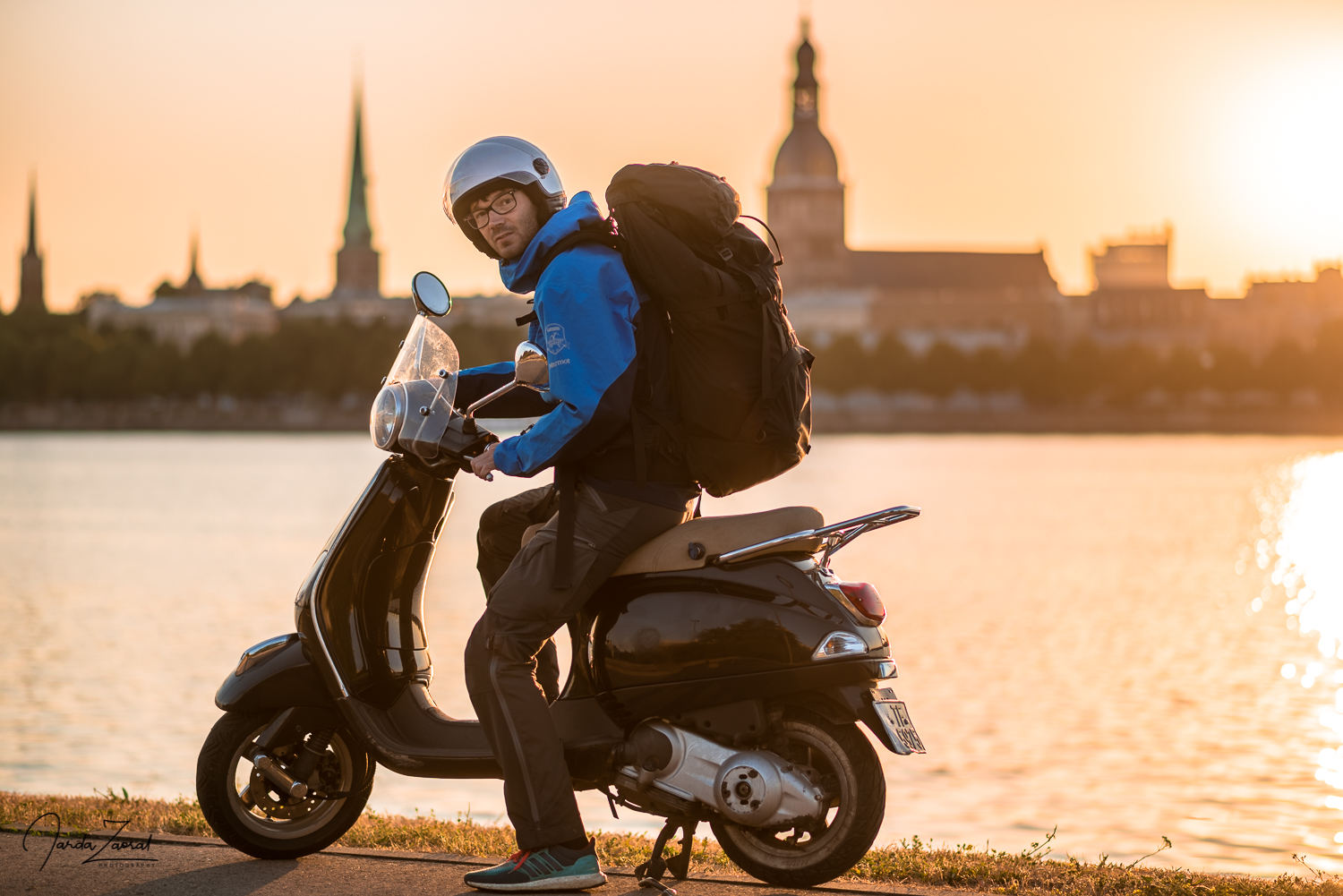 Scooter rider in Riga during sunrise 
