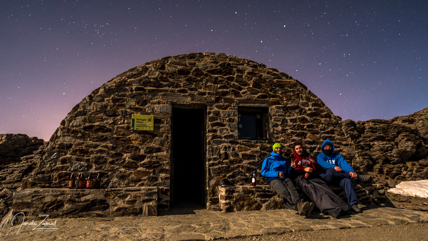 Three friends taking a beer at Bivouac Carihuela 