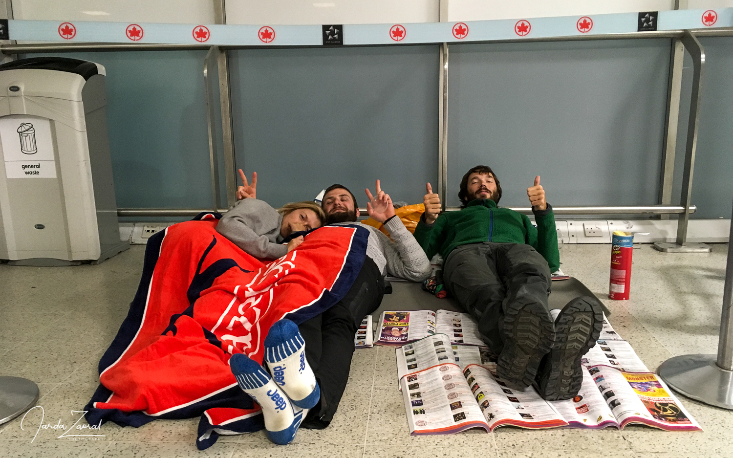 Three desperate tourists lying on floor at Edinburgh airport