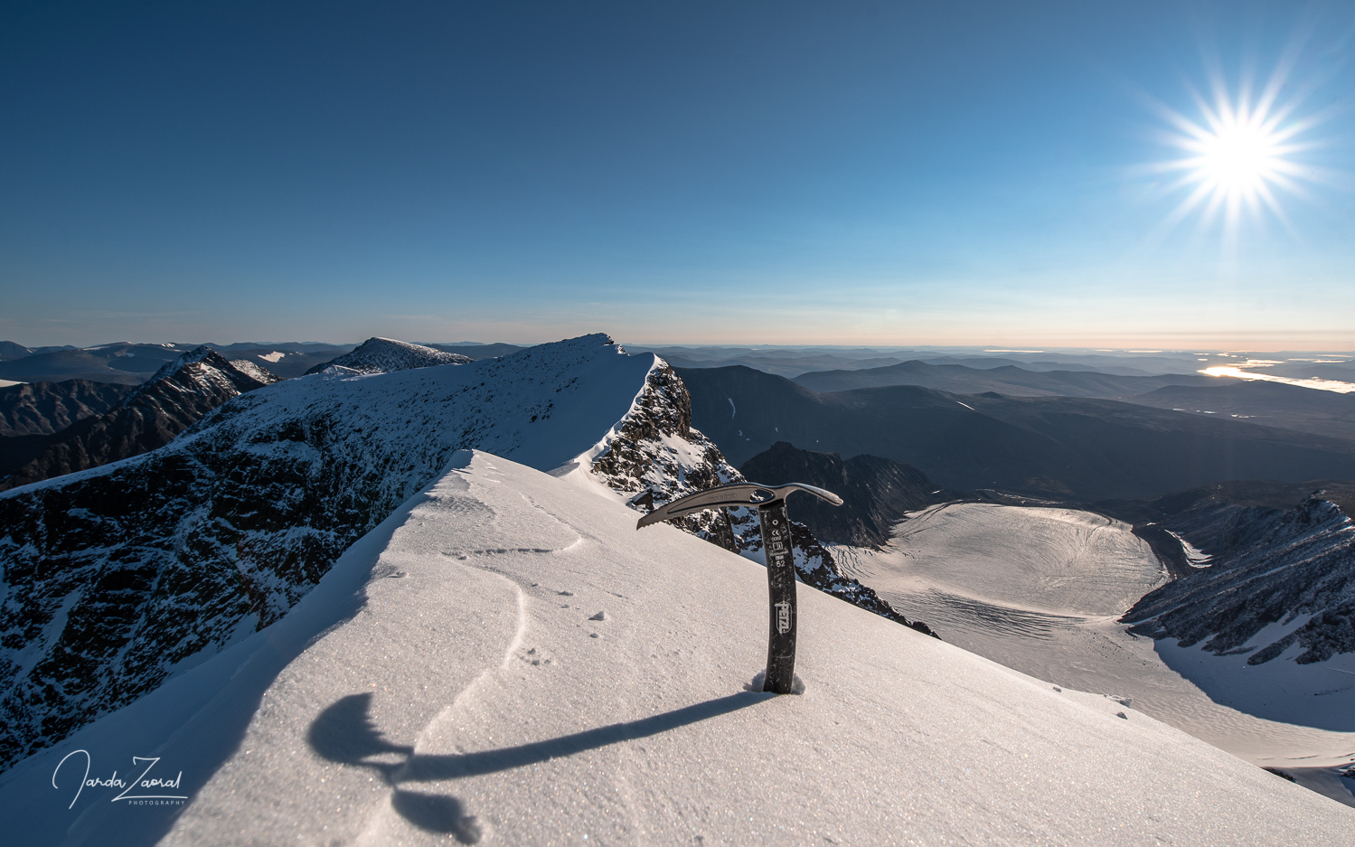 Ice axe on top of Kebnekaise during sunrise with fantastic view