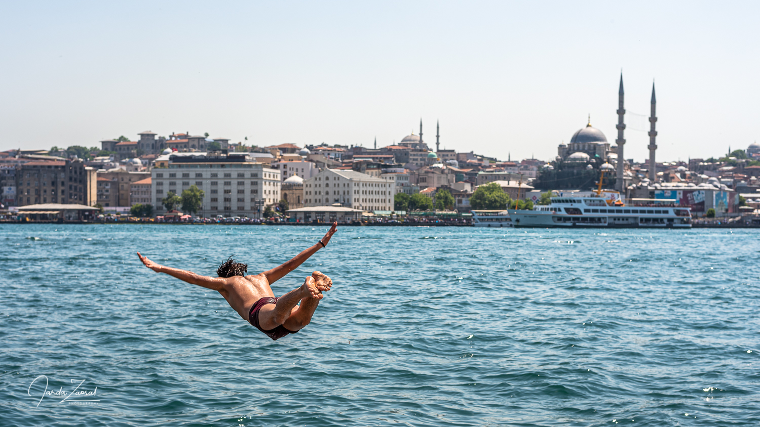 A boy jumps into water in Istanbul