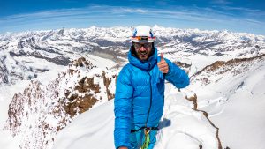 Climber shows a perfect view from mountain Dufourspitze