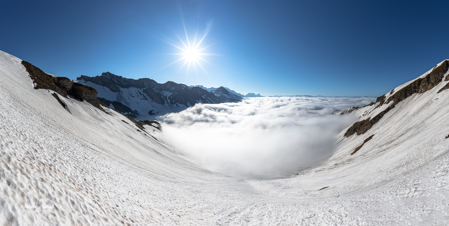 Sunrise above clouds in Swiss mountains