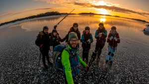 Selfie of group of skaters on a Swedish lake during sunset