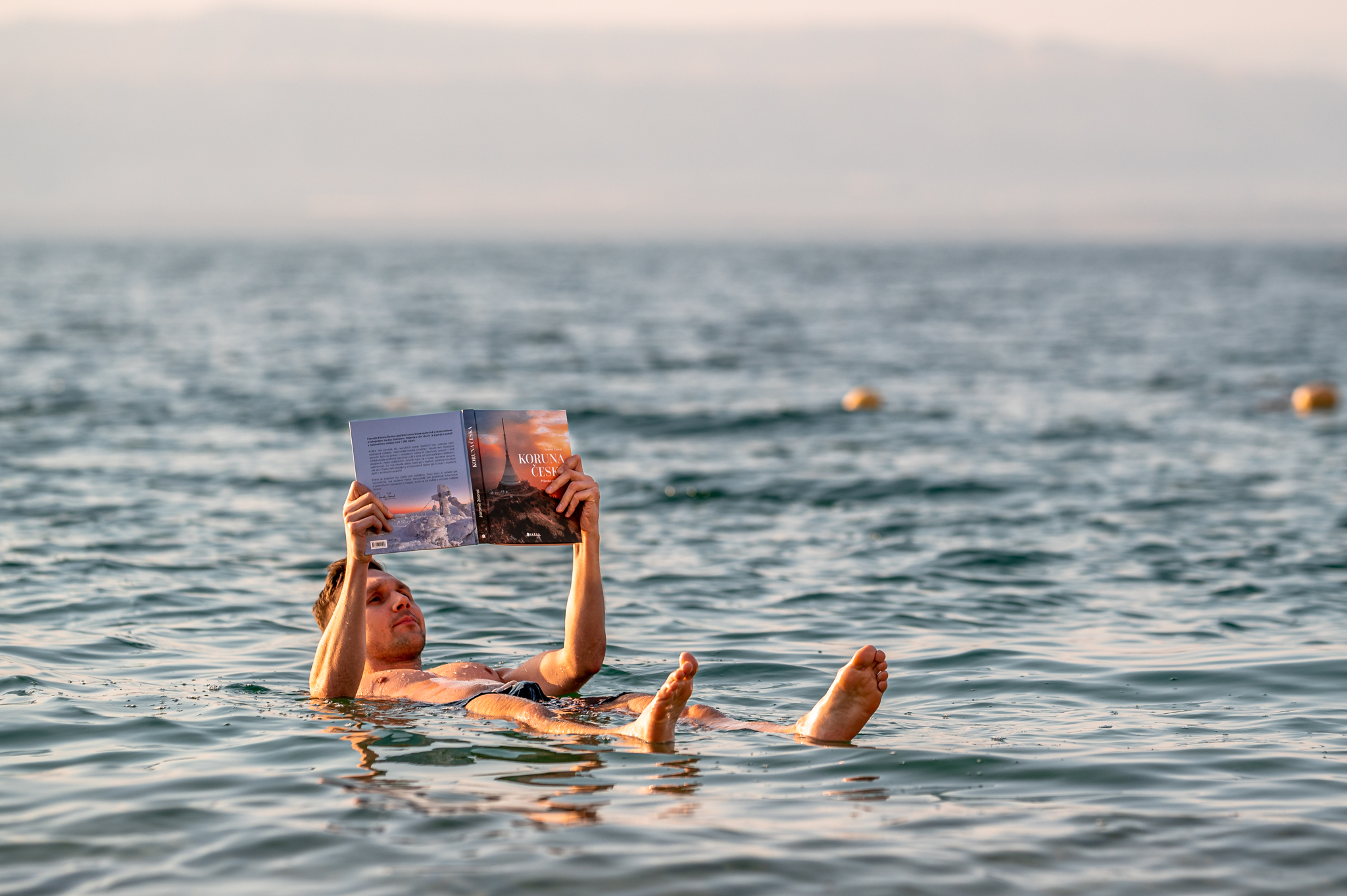 Reading a book at Dead Sea