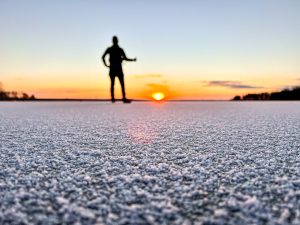 Nordic skating on natural ice during sunset