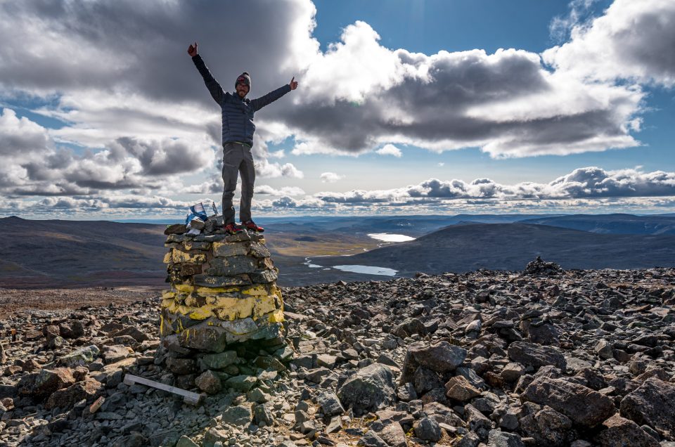 Hiker on top of Finland's highest mountain Halti