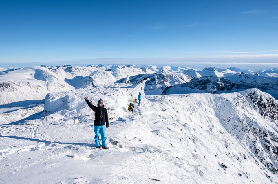 A climber celebrating successful summit of Galdhøpiggen