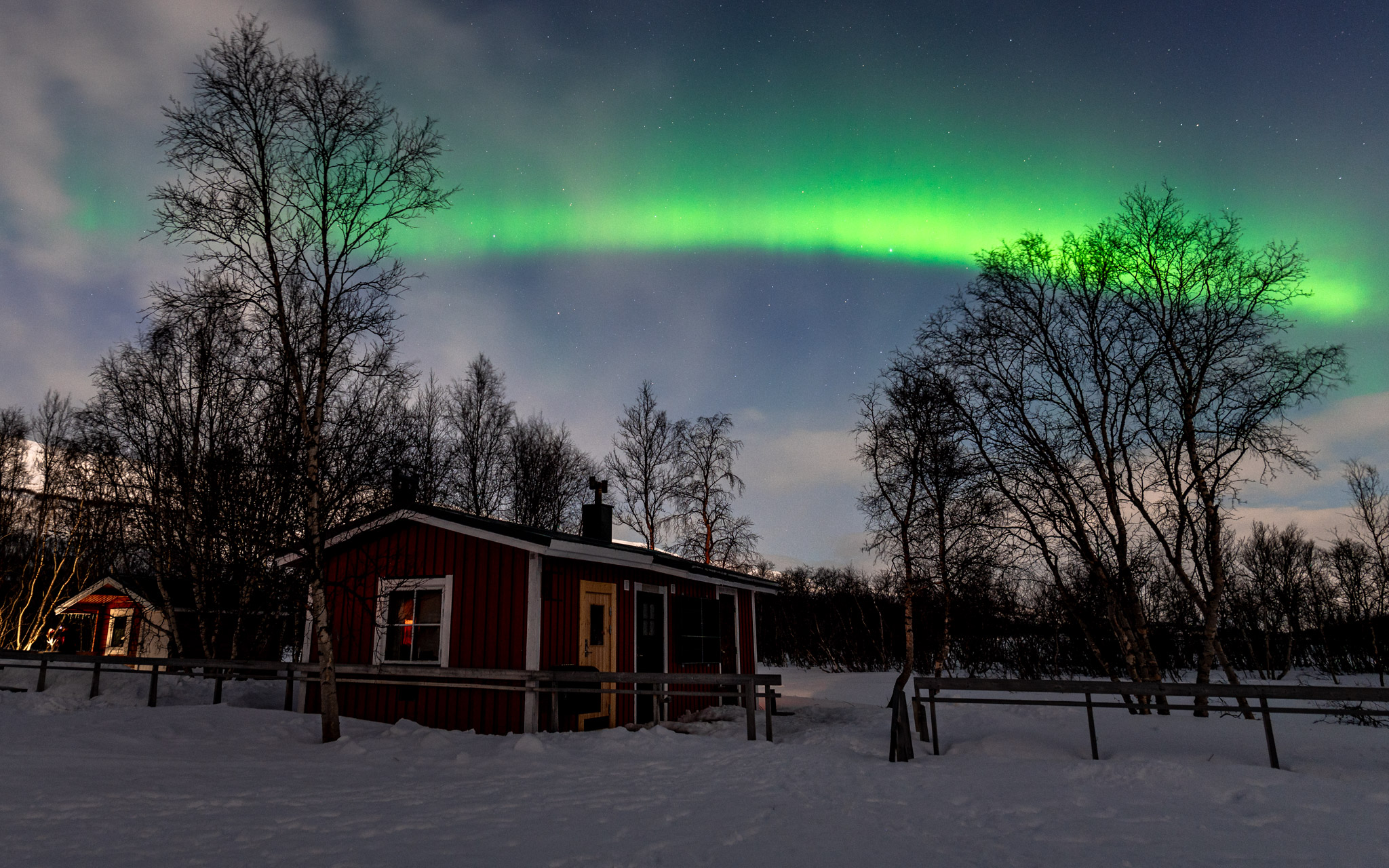 Aurora borealis over the huts in the Sámi village Abiskojaure